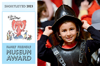 A smiling young girl dressed up in replica Civil War armour with the 'Shortlisted for Family Friendly Museum Award' badge to the left